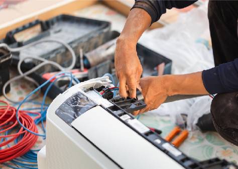 HVAC technician repairing an air conditioning unit