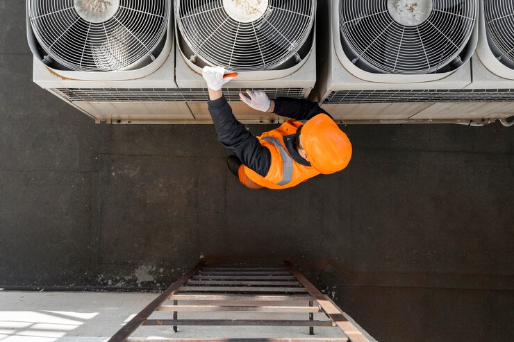 HVAC technician servicing commercial rooftop air conditioning units