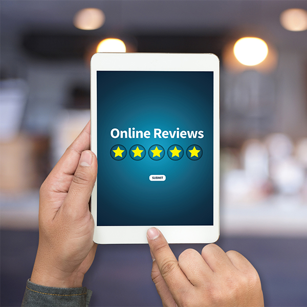 Online reviews displayed on a tablet with five-star rating